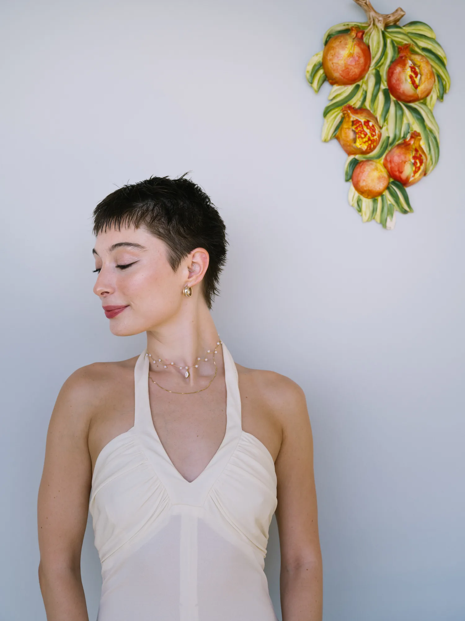 The photograph features a bride wearing a cream-colored halter neck dress with a deep V-neckline.
