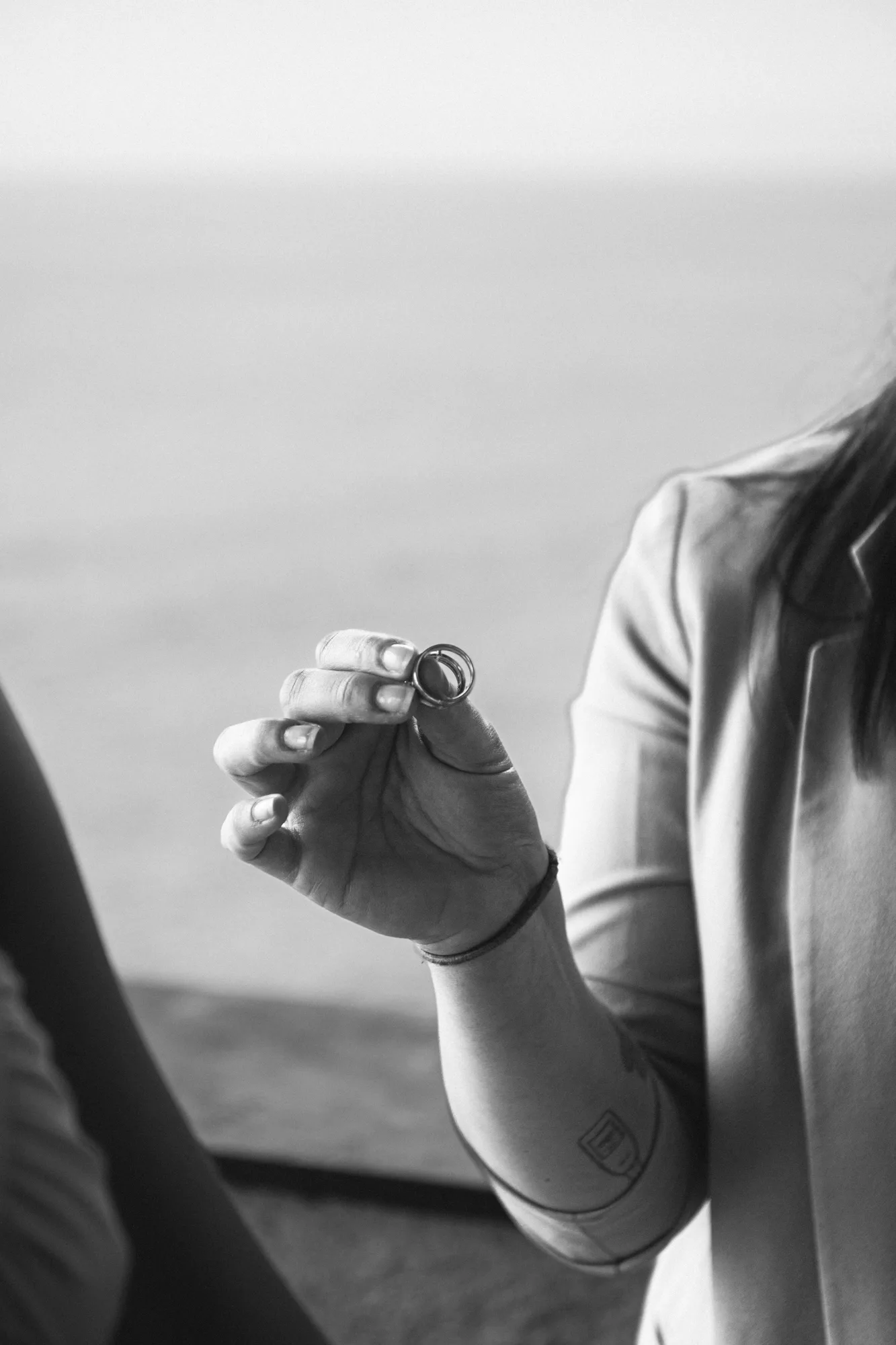 The wedding celebrant is holding a small object, possibly a ring, in their hand.