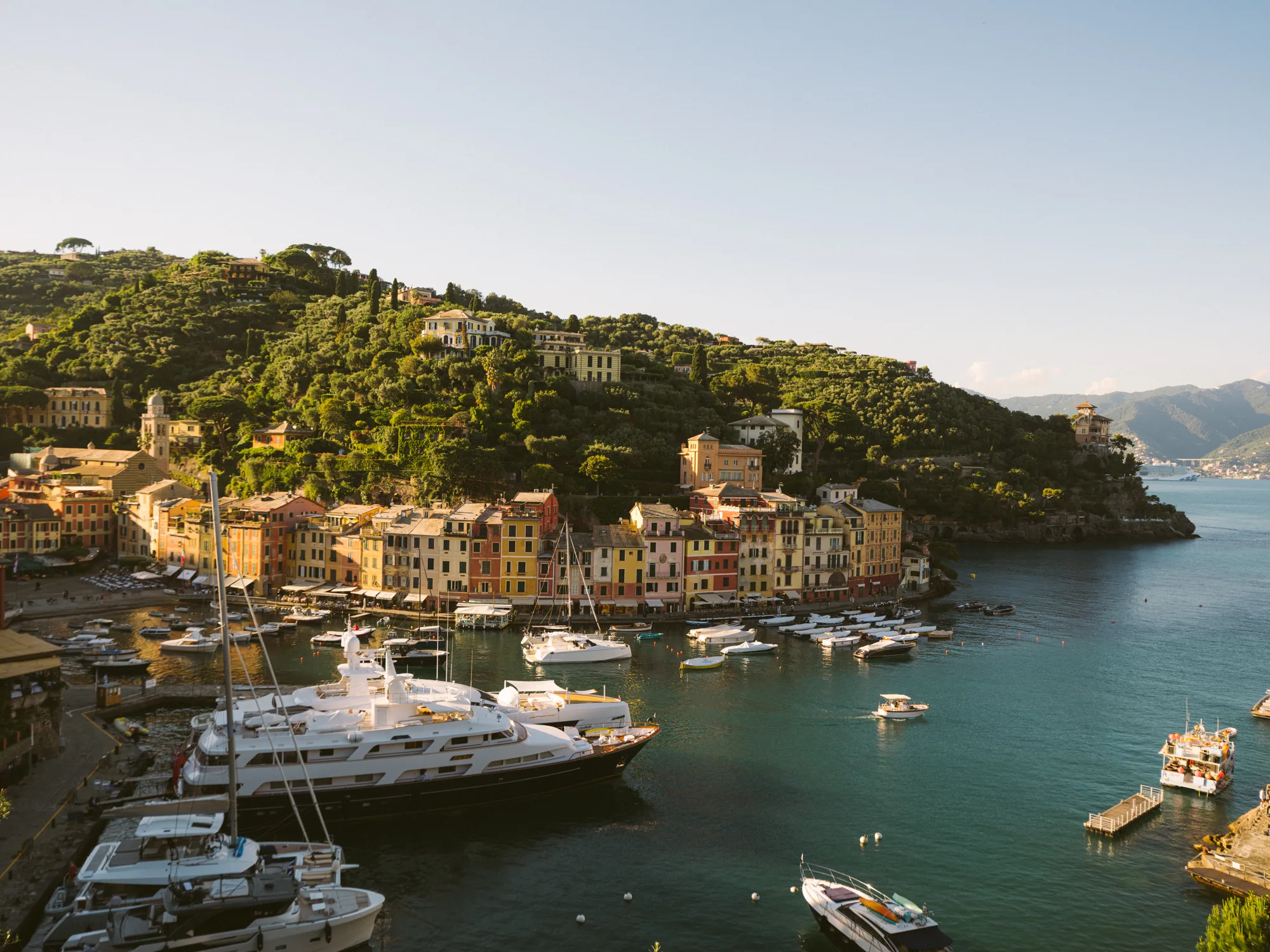 The Portofino photograph shows a picturesque coastal town with colorful buildings and a hillside covered in greenery.