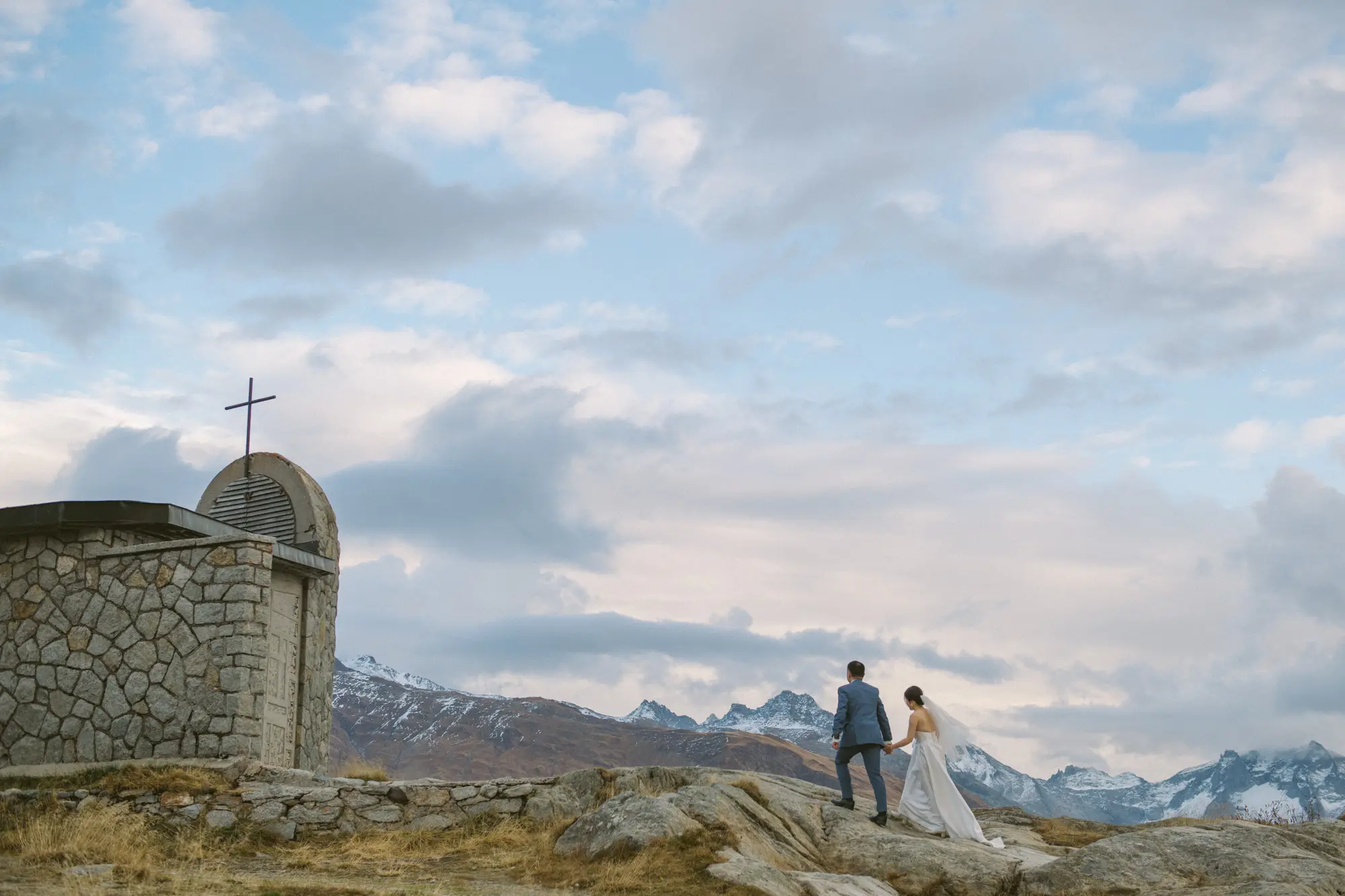 Swiss Alps pre-wedding photography beside a mountain church in Switzerland