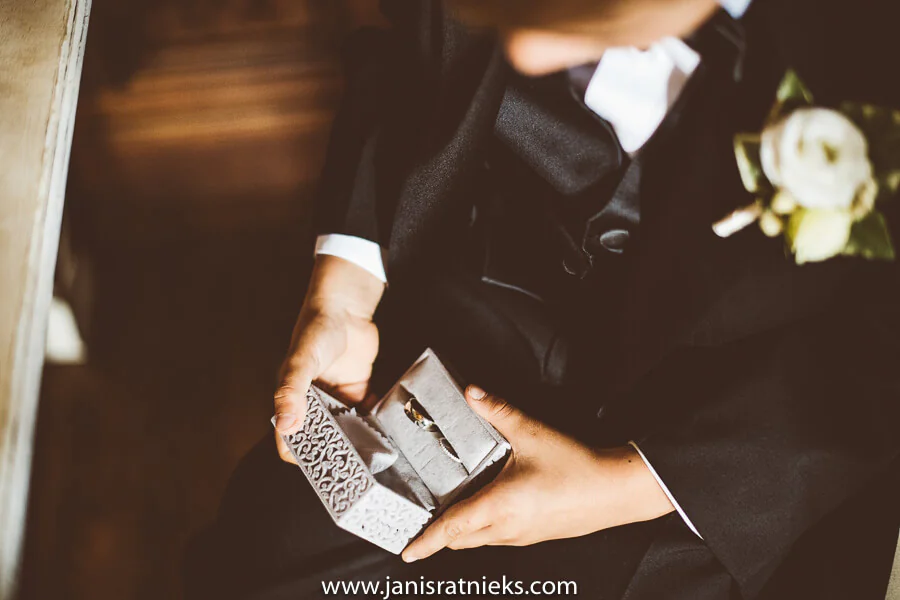 Ring boy holding wedding ring in his hands