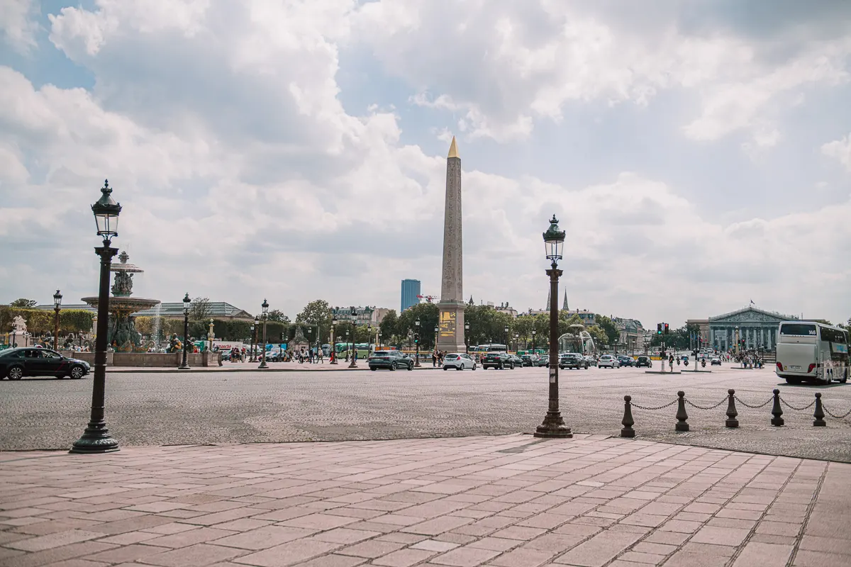 A view of Place de la Concorde in Paris, France, with its iconic Egyptian obelisk and grand architecture.