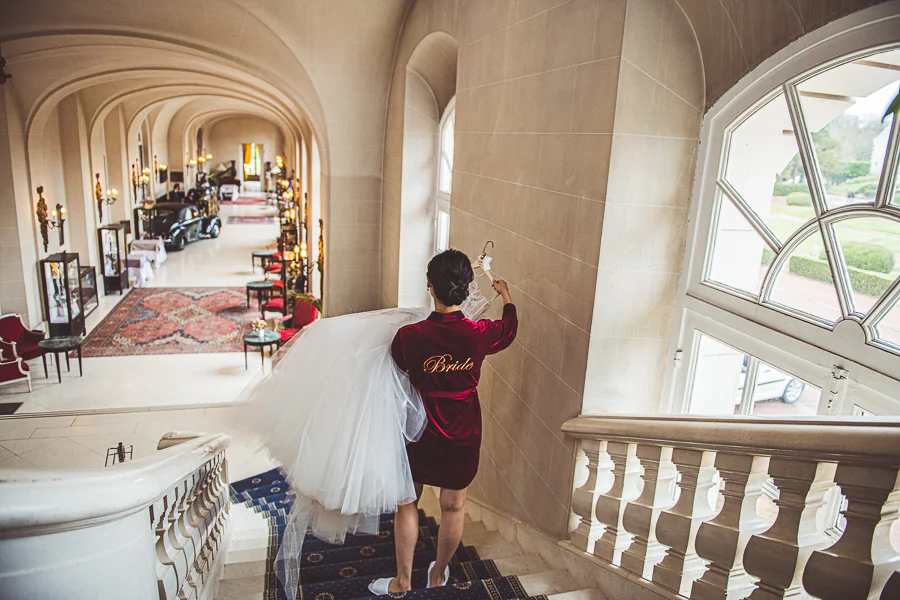 Bride carrying her wedding dress