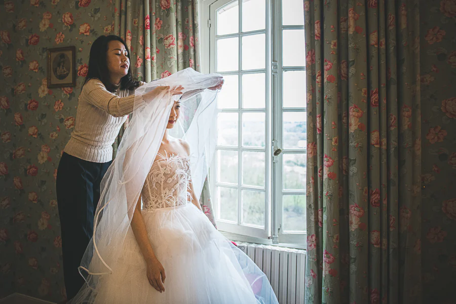 bride putting on her wedding dress