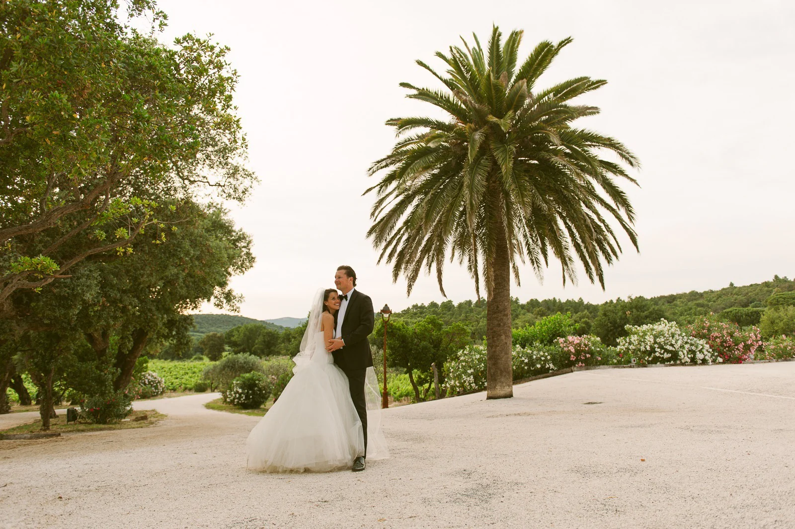 Bride resting head on groom's shoulder in vineyard near Saint-Tropez