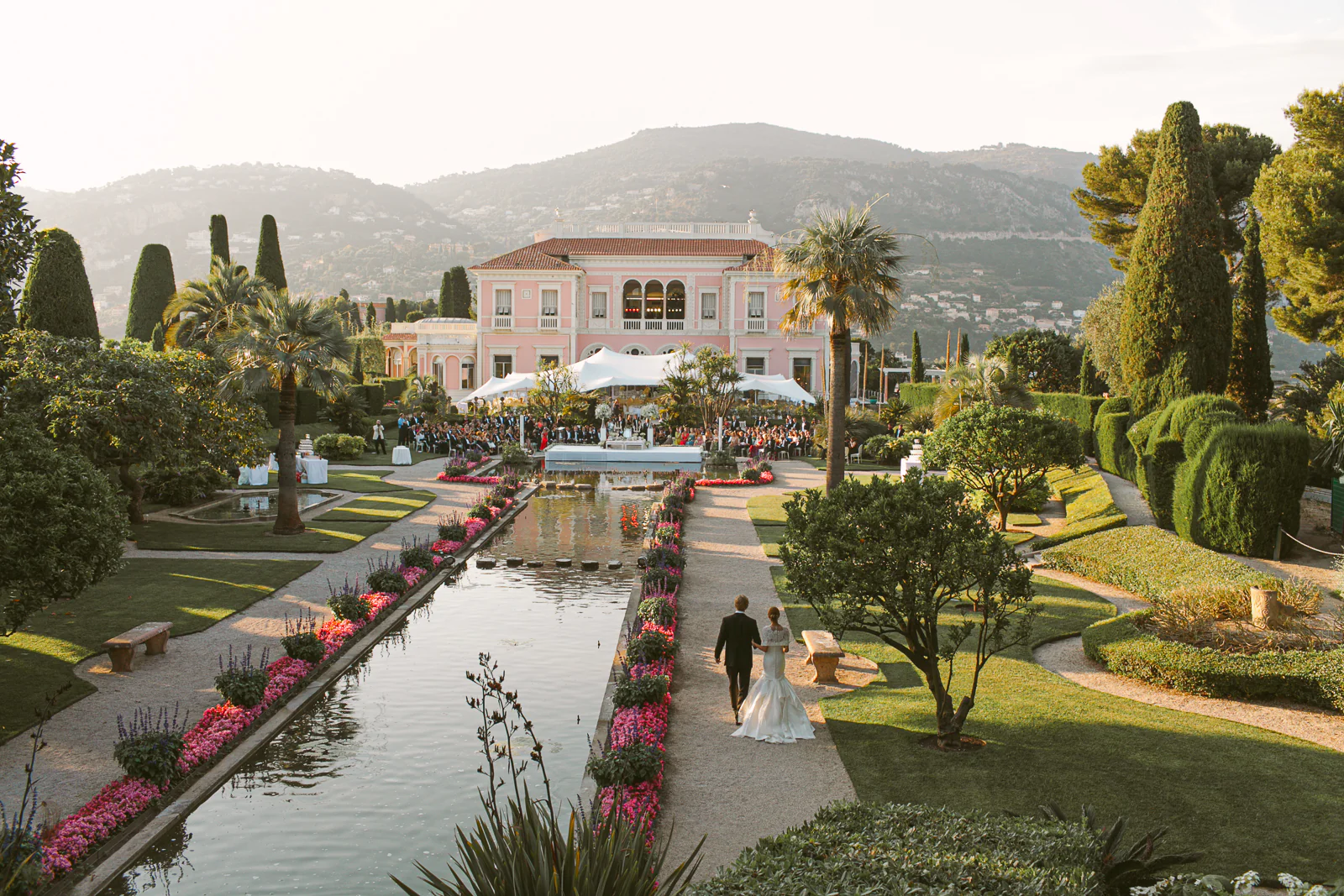 Elegant wedding portrait on the terrace of Villa Ephrussi de Rothschild overlooking the French Riviera coastline.