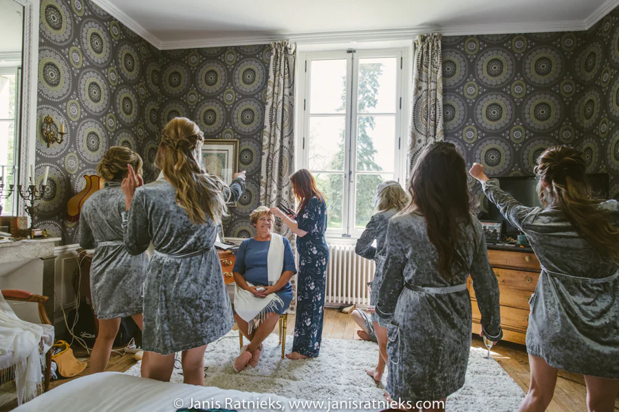 Bridesmaids in coordinated grey velvet robes before the ceremony