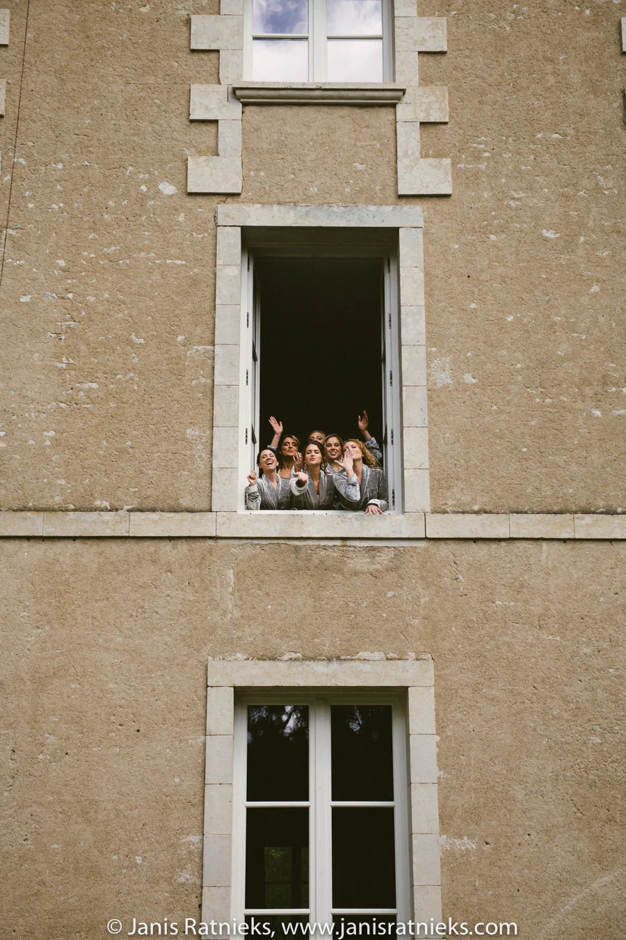 Stone façade and open window at Château de la Borderie