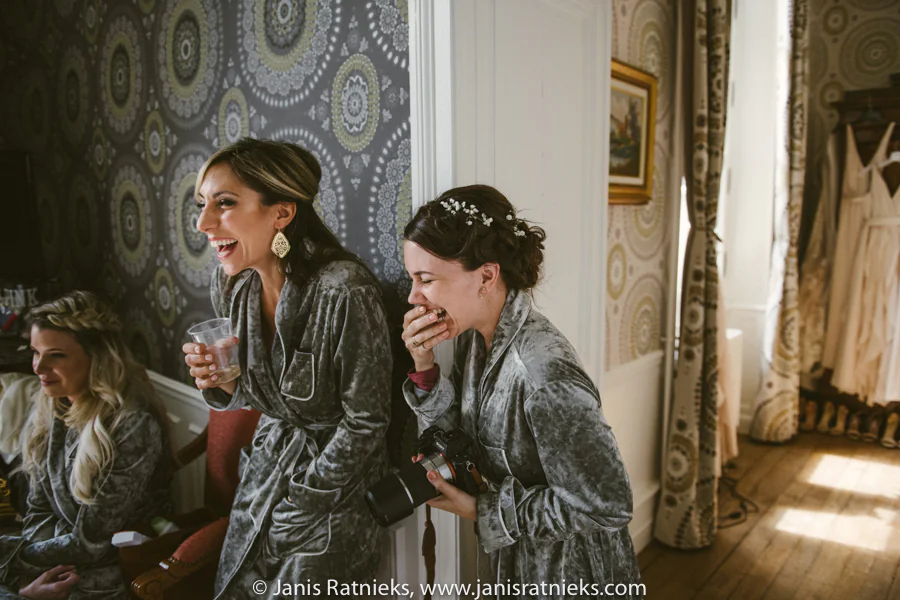 Bridesmaids laughing together during morning preparations