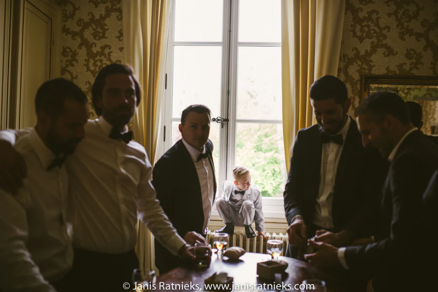 Groomsmen sharing a candid moment before the ceremony
