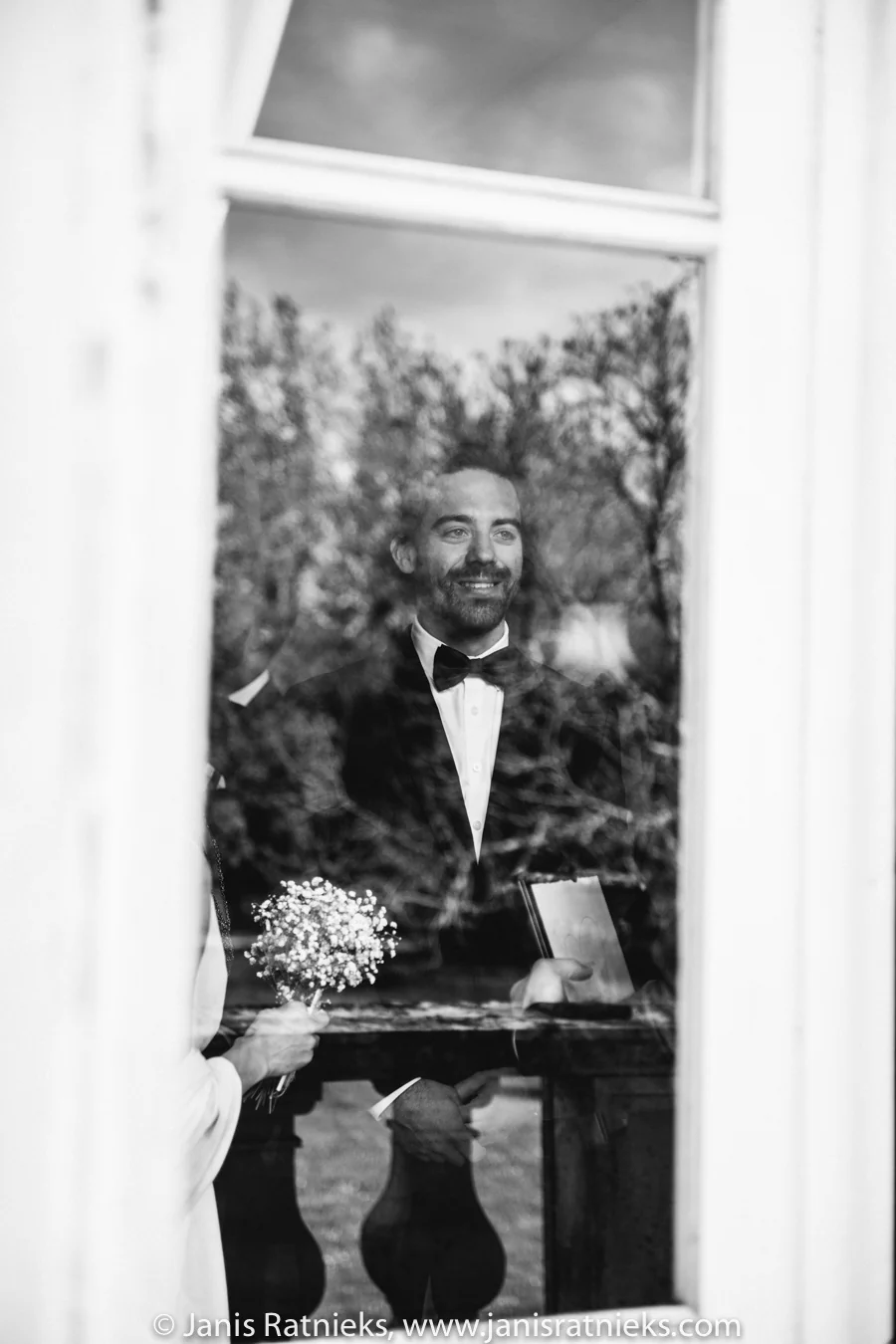 Groom waiting in the château doorway before the ceremony