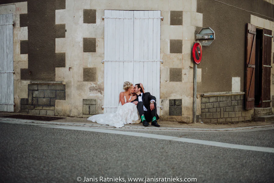 Bride and groom portrait near a village road sign