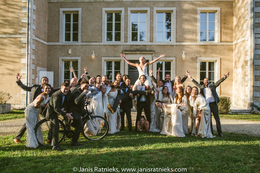 Wedding party celebrating together outside Château de la Borderie