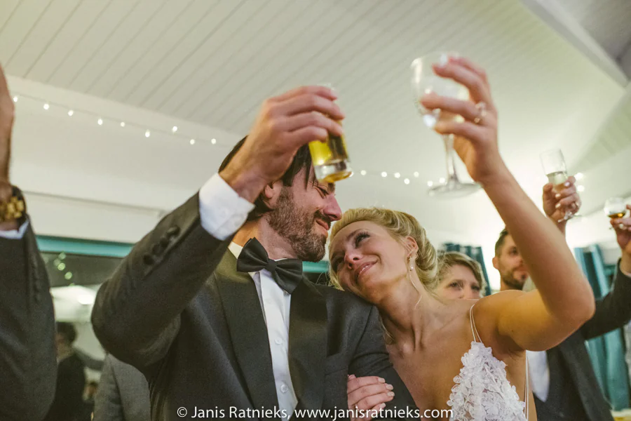 Ramon and Rebecca cheering with their wedding guests