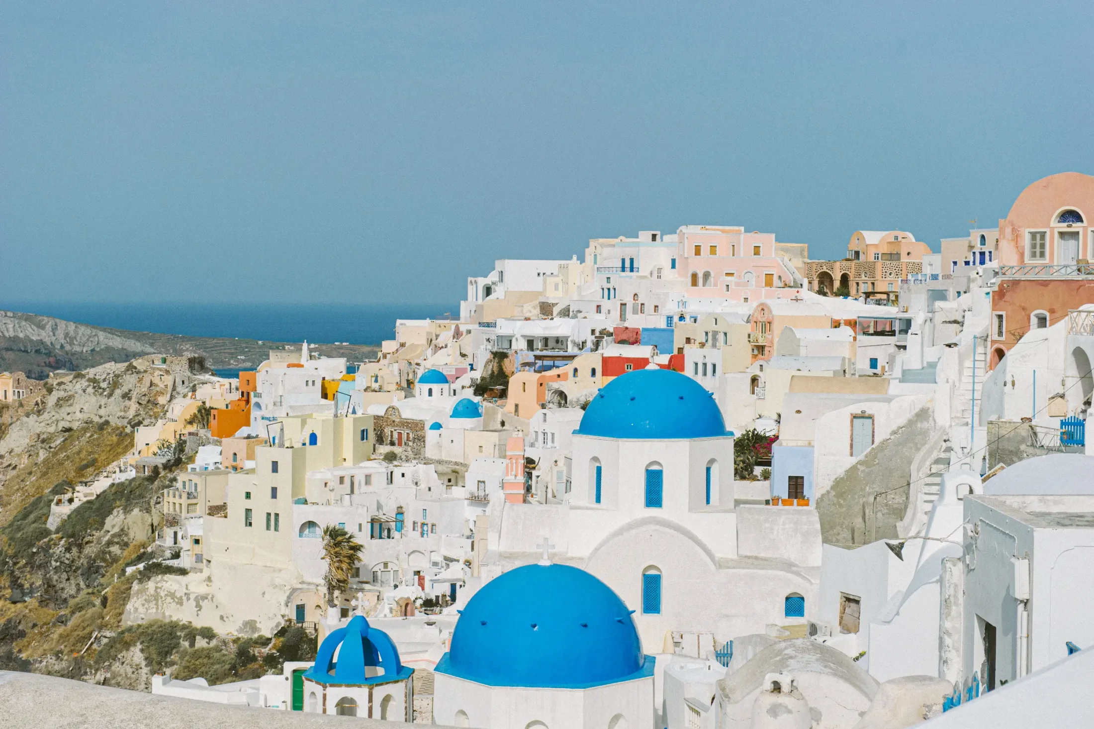 Santorini pre-wedding portrait with whitewashed island architecture