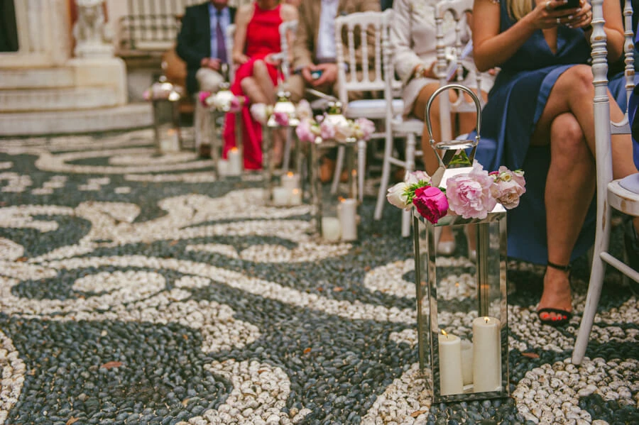 Flowers and candles lining the patterned stone aisle at Villa Durazzo