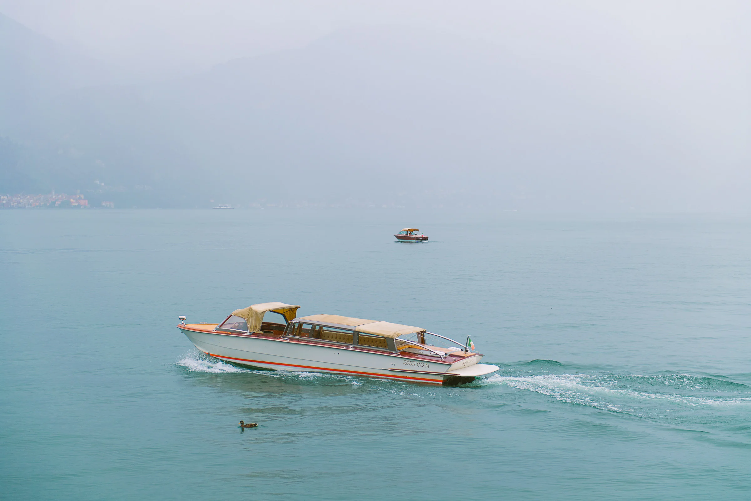 Jane and Lucas on Lake Como during their Riva boat elopement portraits, photograph 40