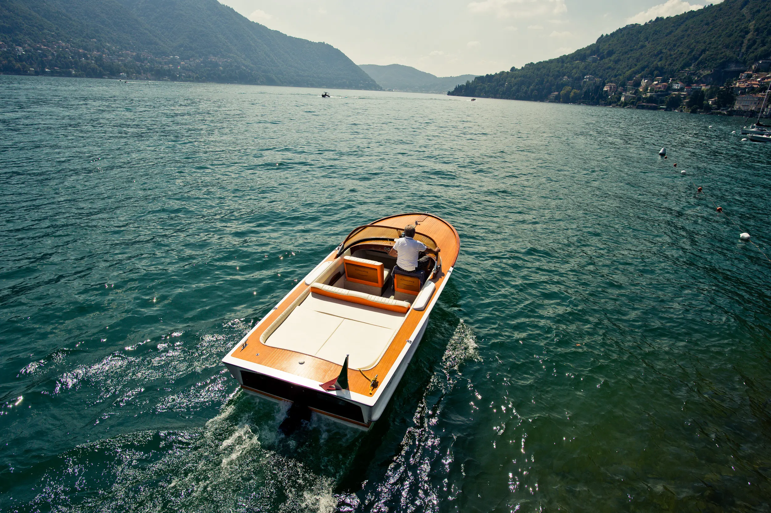 Elegant portrait at a Lake Como villa balcony with mountains behind