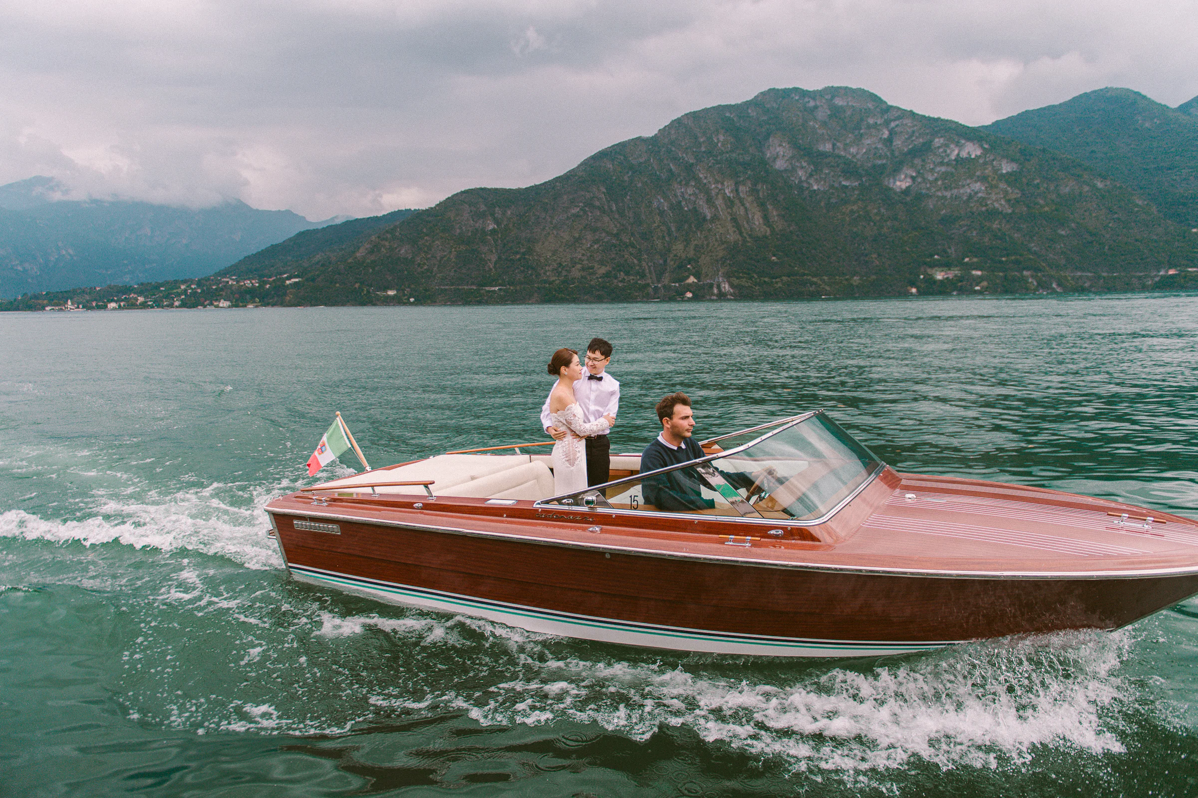 Couple on a classic wooden boat during a Lake Como photoshoot