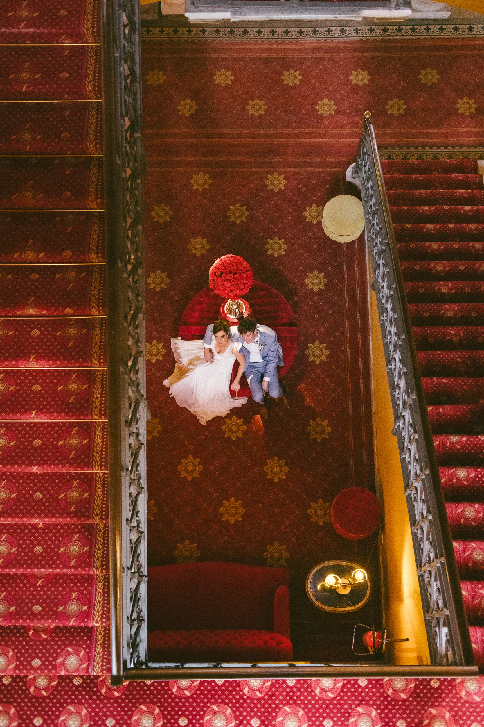 wedding photograph of a bride and groom in the stairs of hotel Tremezzo during their lake como wedding taken by wedding