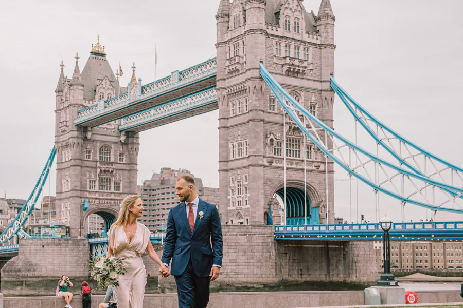 A romantic couple embracing each other in a picturesque outdoor setting, captured by Janis Ratnieks, a renowned European wedding photographer.