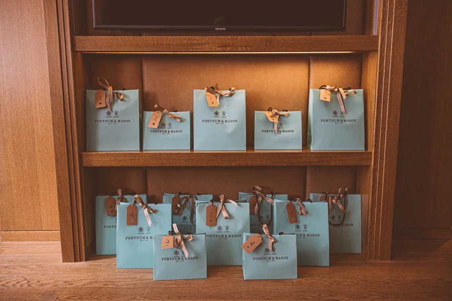 Wedding gift bags arranged on a shelf at Corinthia London