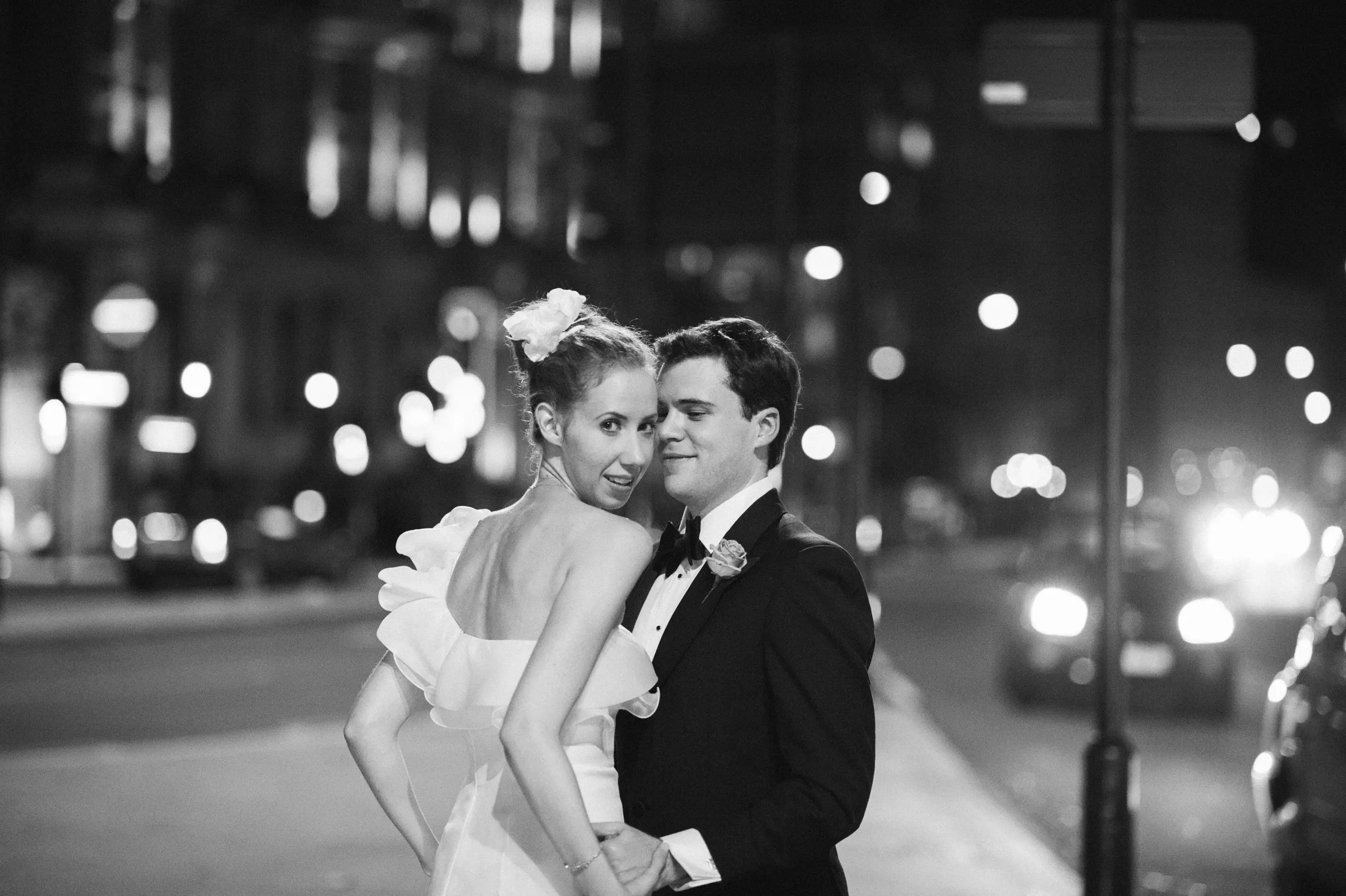 Black-and-white night portrait of Fiona and Ben on a London street