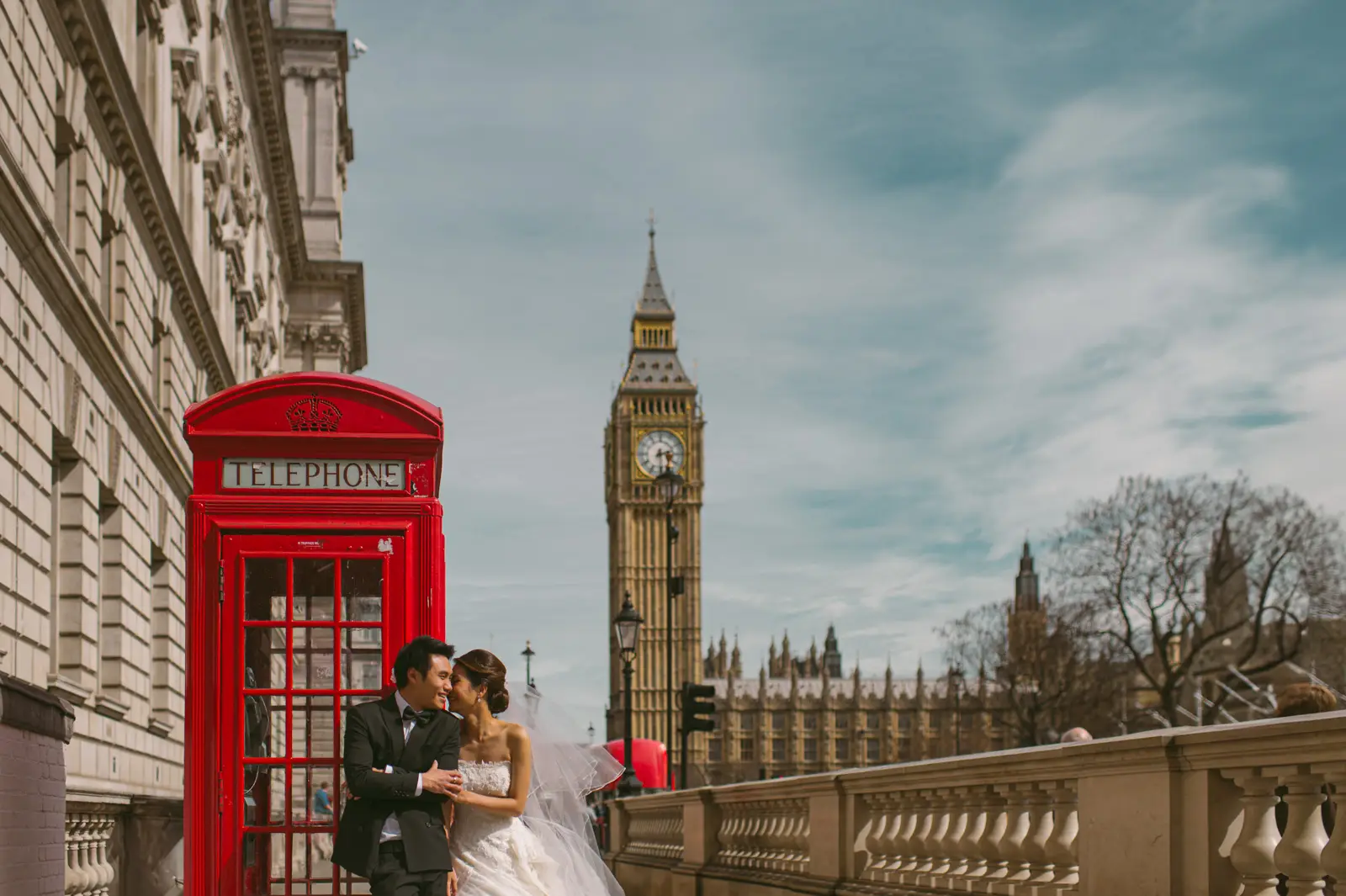 London pre-wedding portrait beside a red telephone box with Big Ben in the background