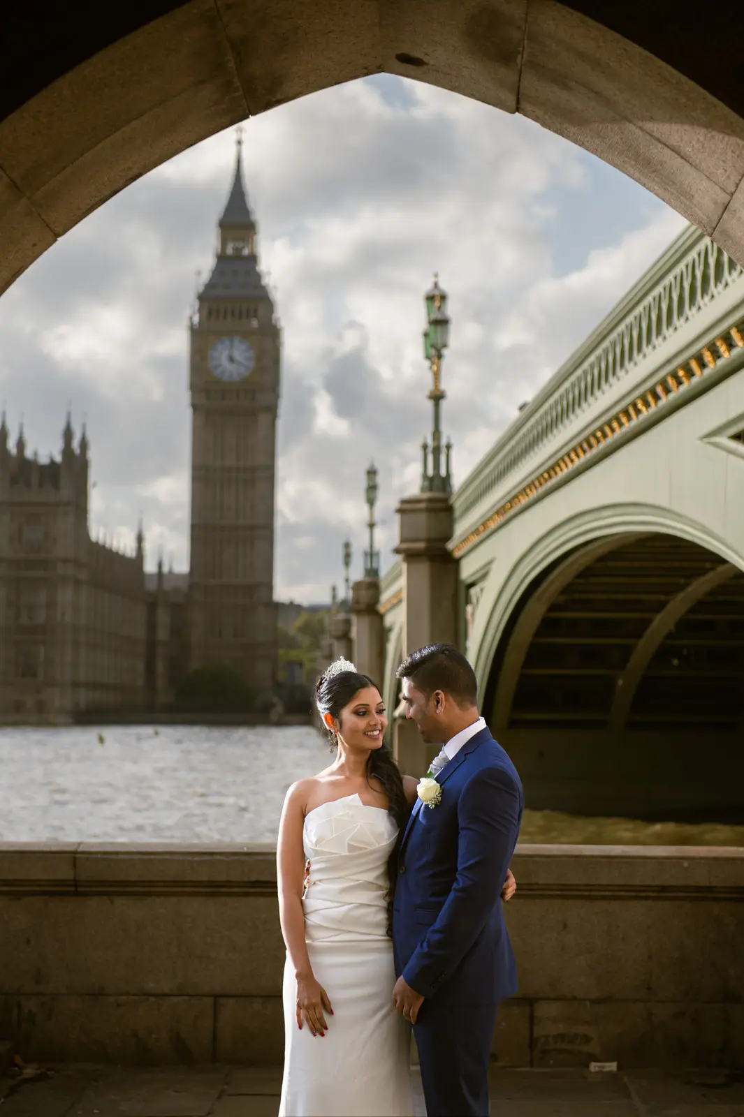 Couple walking through autumn leaves during a London pre-wedding session