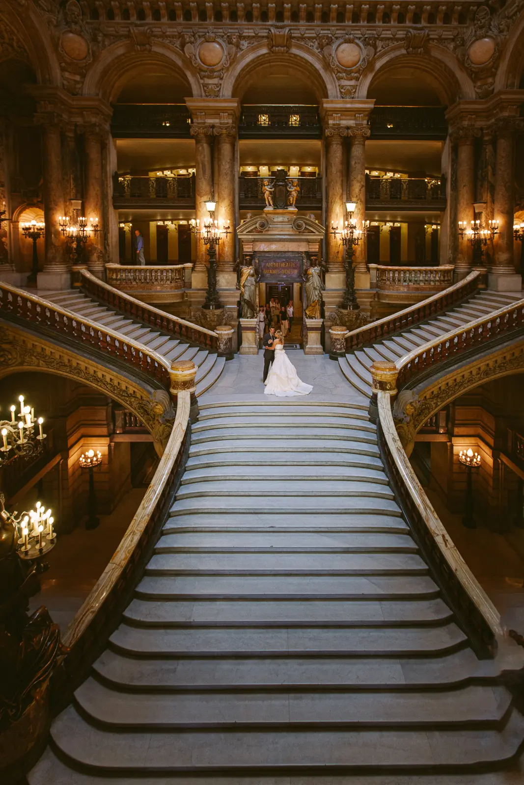 Tabitha and Nathan beneath the gilded interiors of the Paris Opera