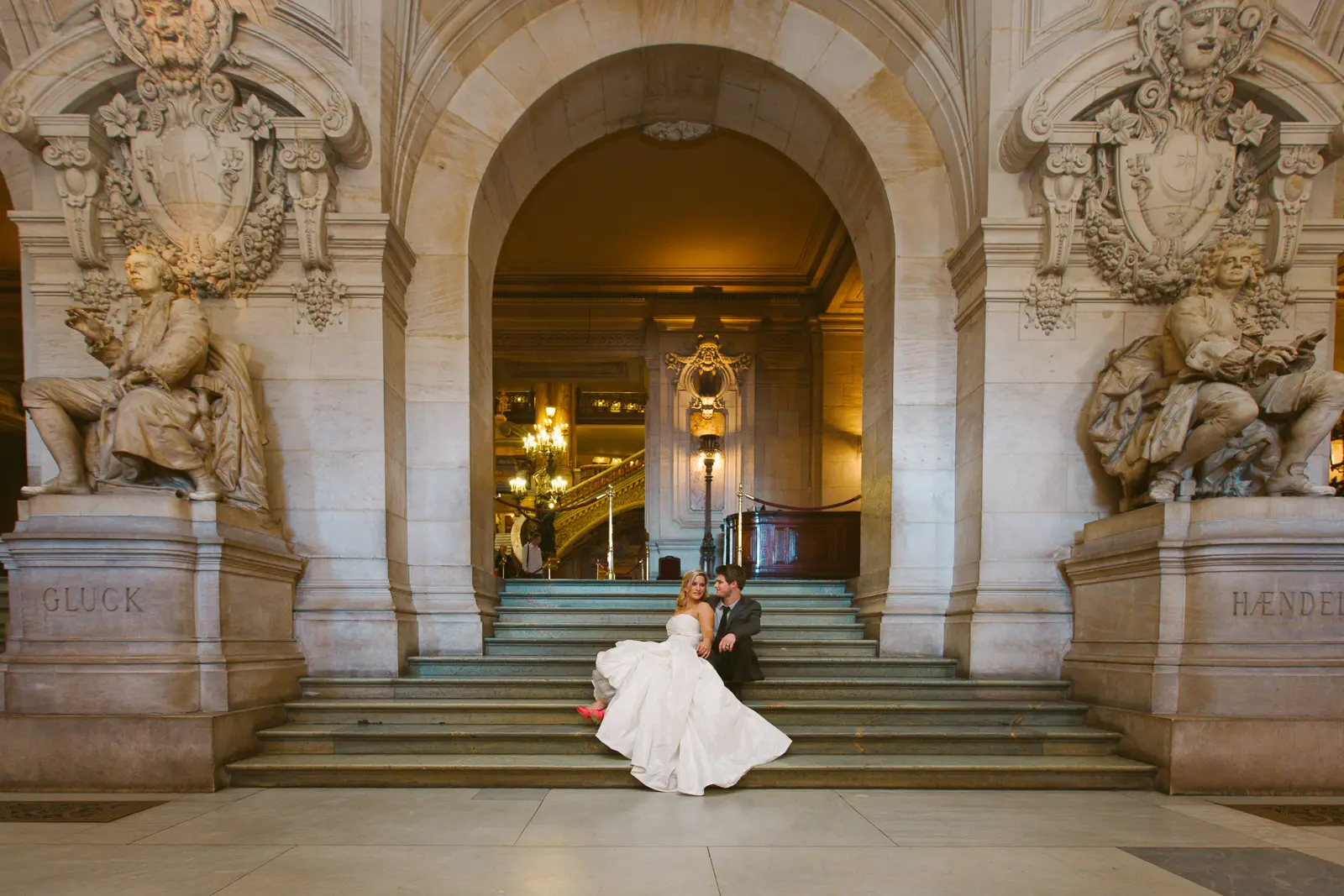 Tabitha and Nathan beneath the gilded interiors of the Paris Opera