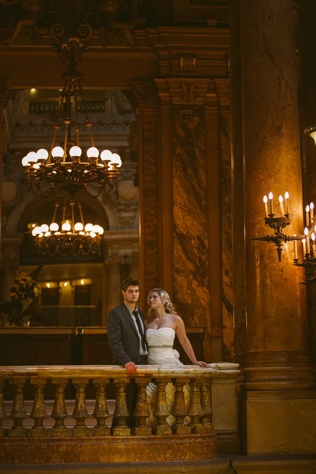Tabitha and Nathan beneath the gilded interiors of the Paris Opera