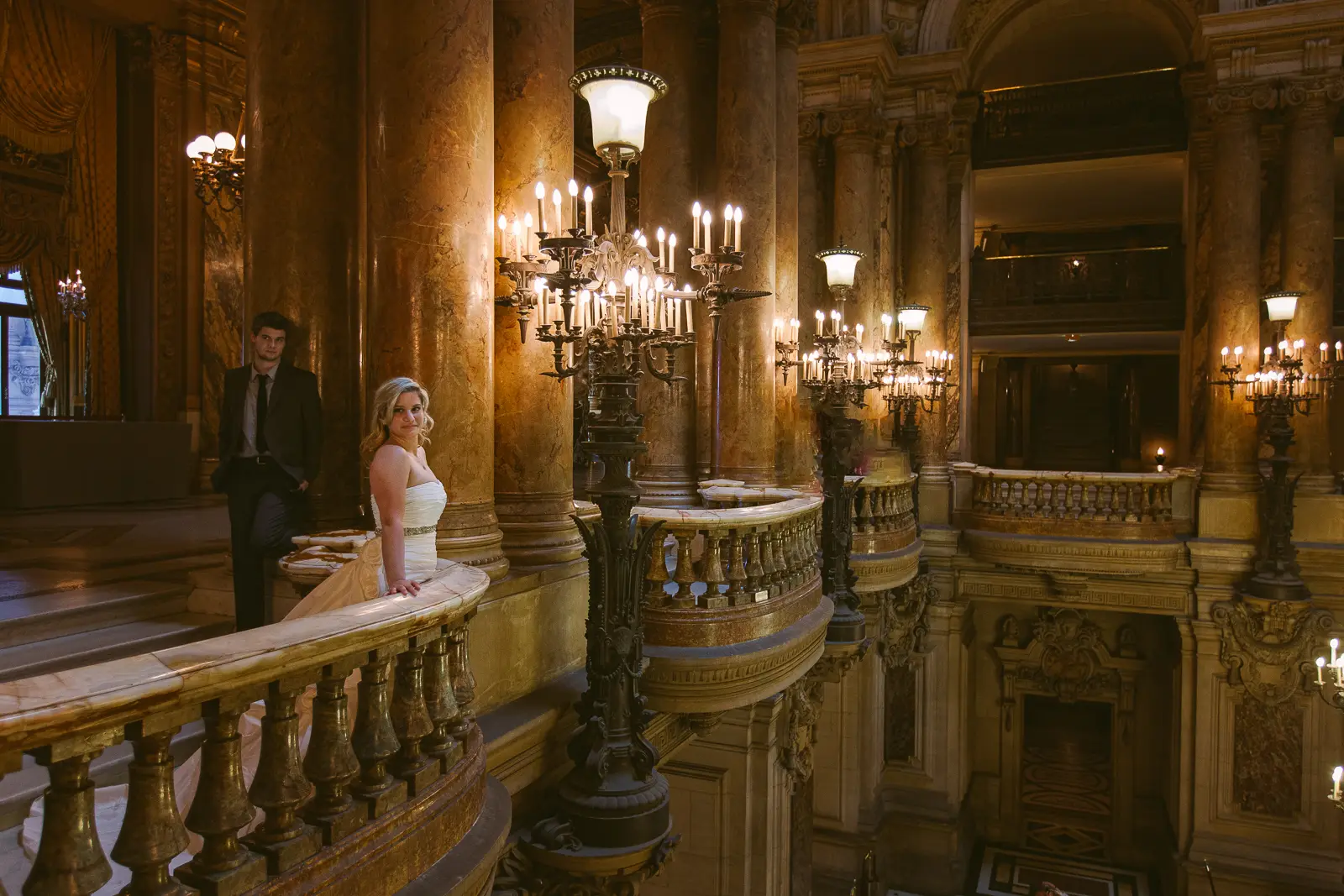 Tabitha and Nathan beneath the gilded interiors of the Paris Opera