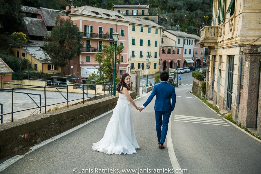 Couple walking hand in hand along a quiet Italian Riviera road