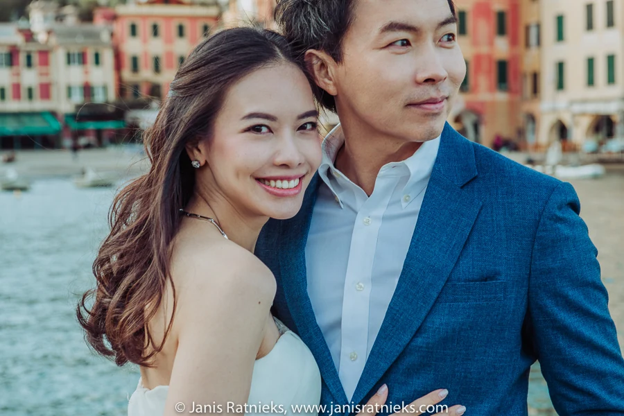 Close portrait of a couple with the Portofino harbour softly behind them