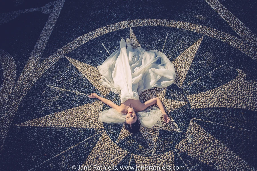 Bride reclining on the black-and-white pebble mosaic terrace at San Giorgio