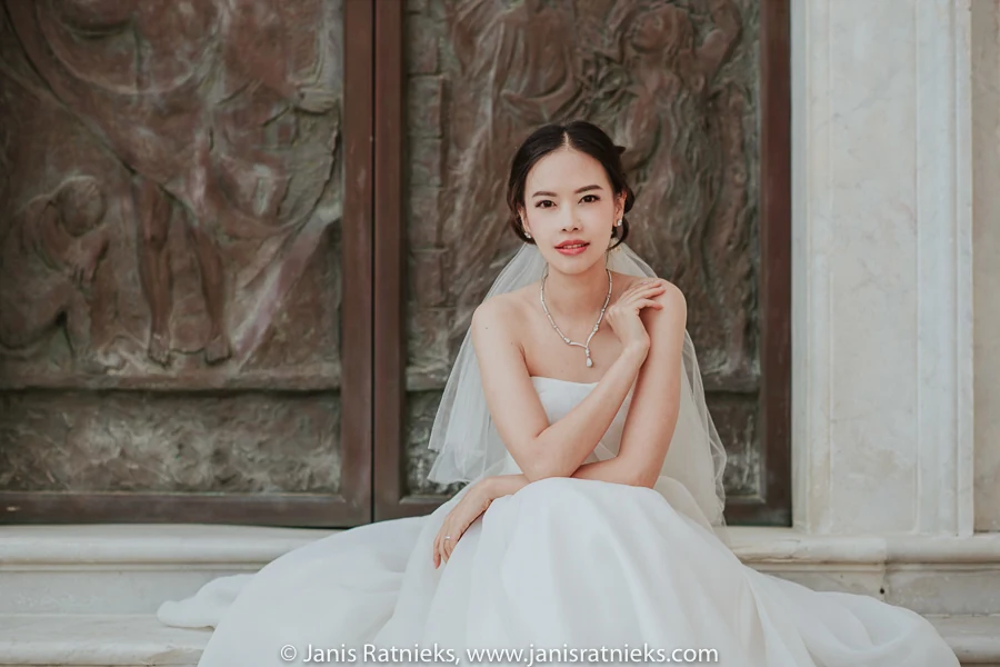 Close bridal portrait against an ornate church doorway