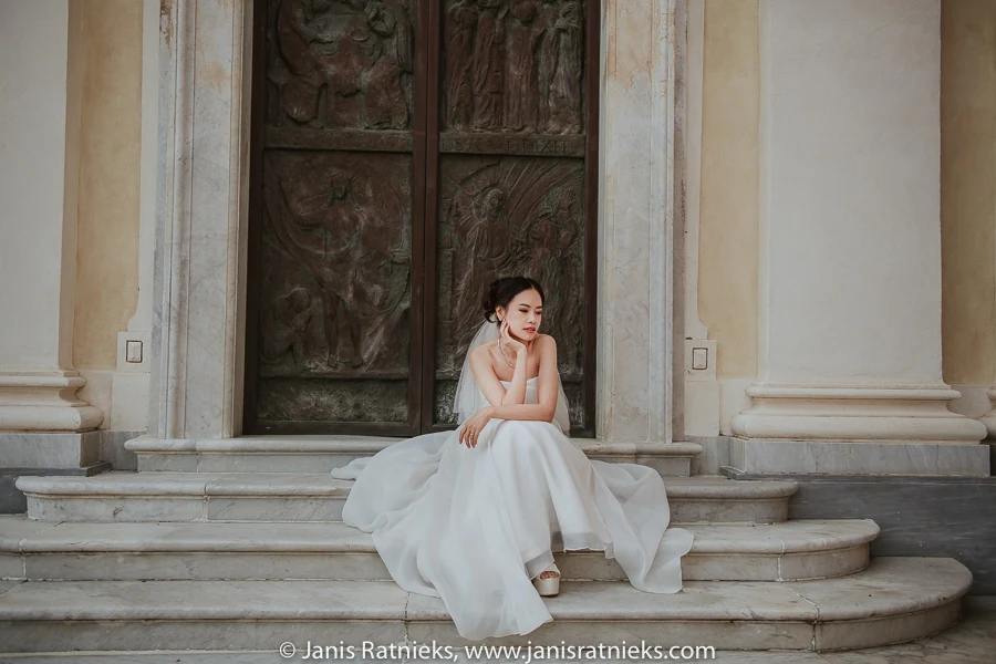 Full bridal portrait seated at the church entrance