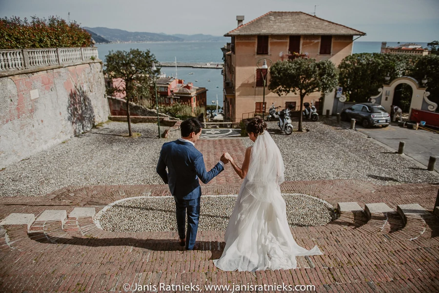 Couple walking down cobbled steps towards the Santa Margherita Ligure waterfront