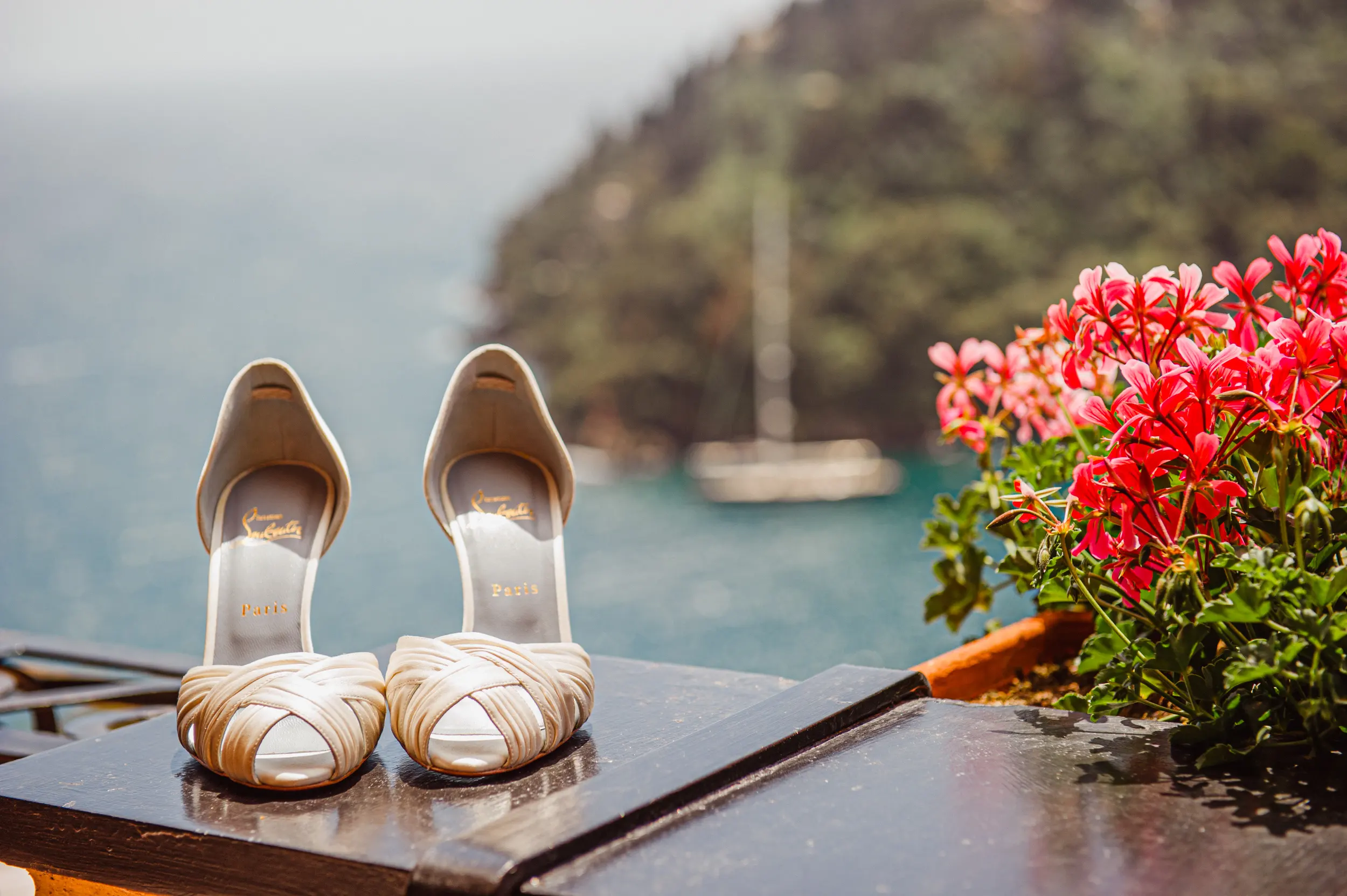 Bridal shoes arranged above the sea during a Hotel Splendido wedding