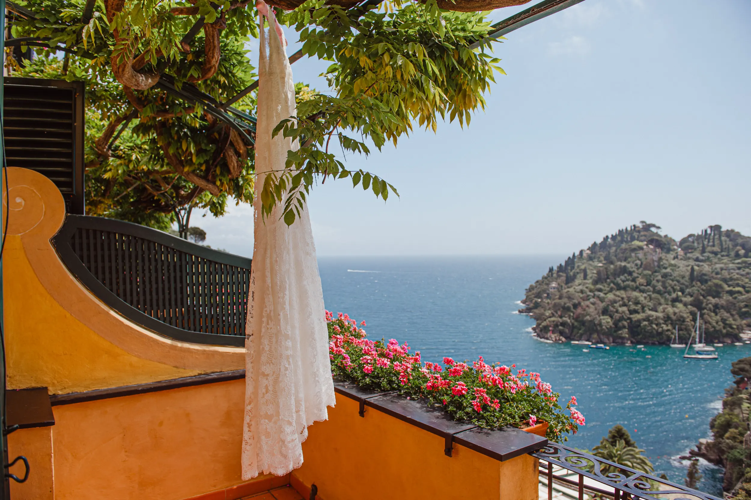 Wedding dress hanging on a terrace overlooking the Portofino coast