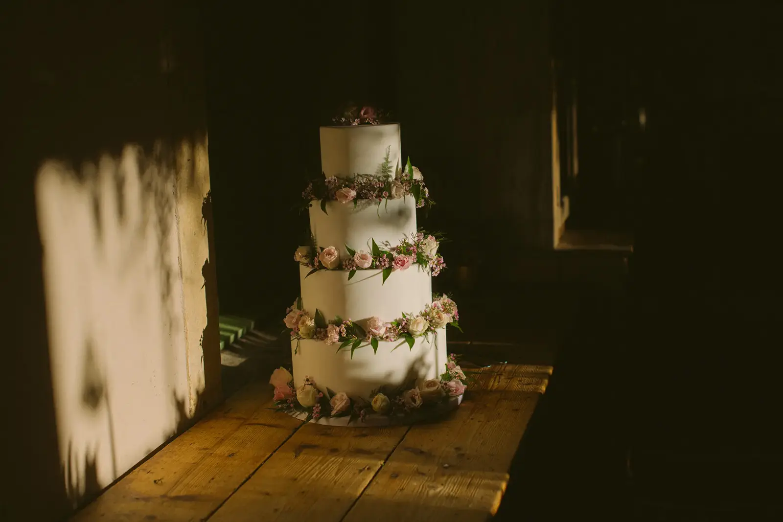 Wedding cake beside a window in warm natural light