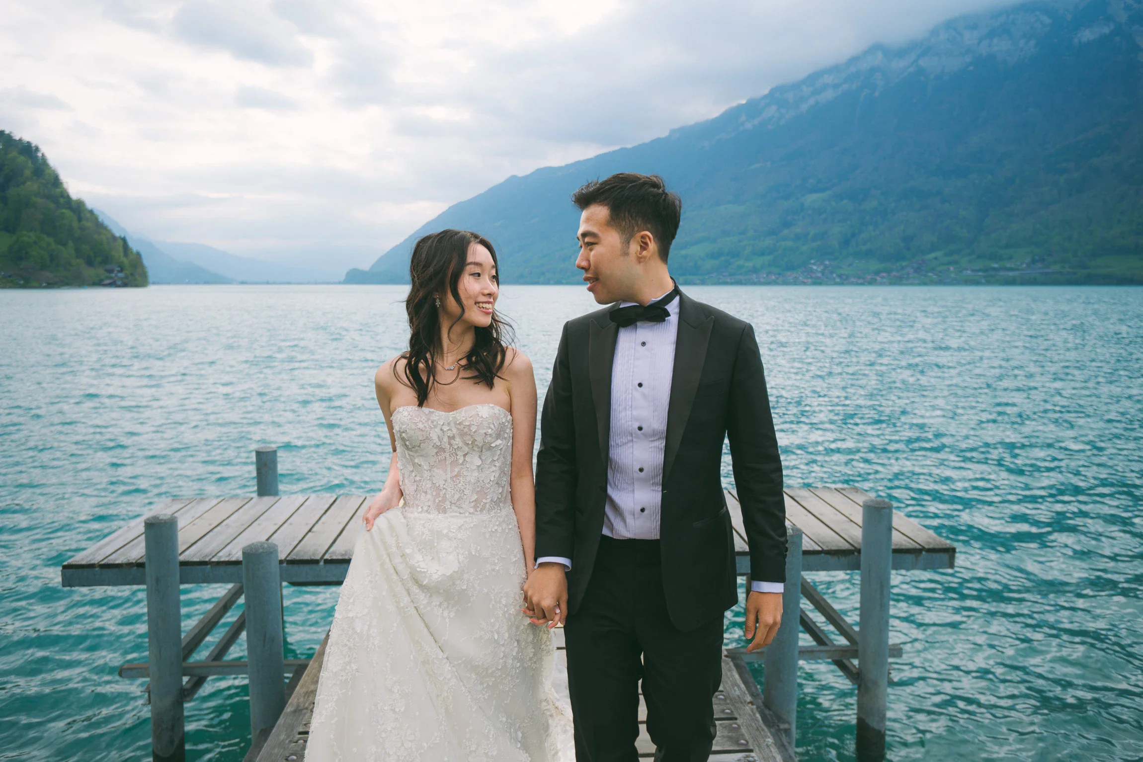 Image 6: Pre-wedding photo of couple by the turquoise waters of Lake Brienz, Switzerland