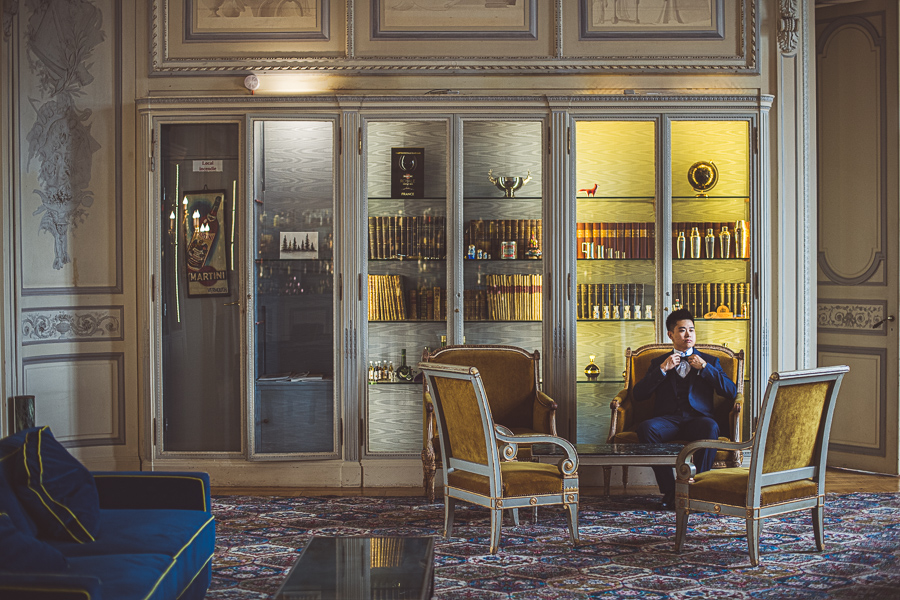 Chinese groom sitting in a blue suit