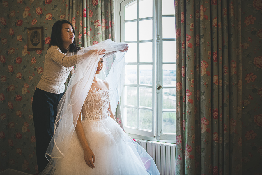 bride putting on her wedding dress
