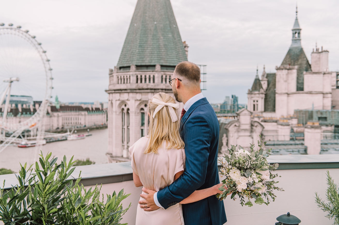 Corinthia hotel London wedding photography bride and groom posing for the photographer on the terrace