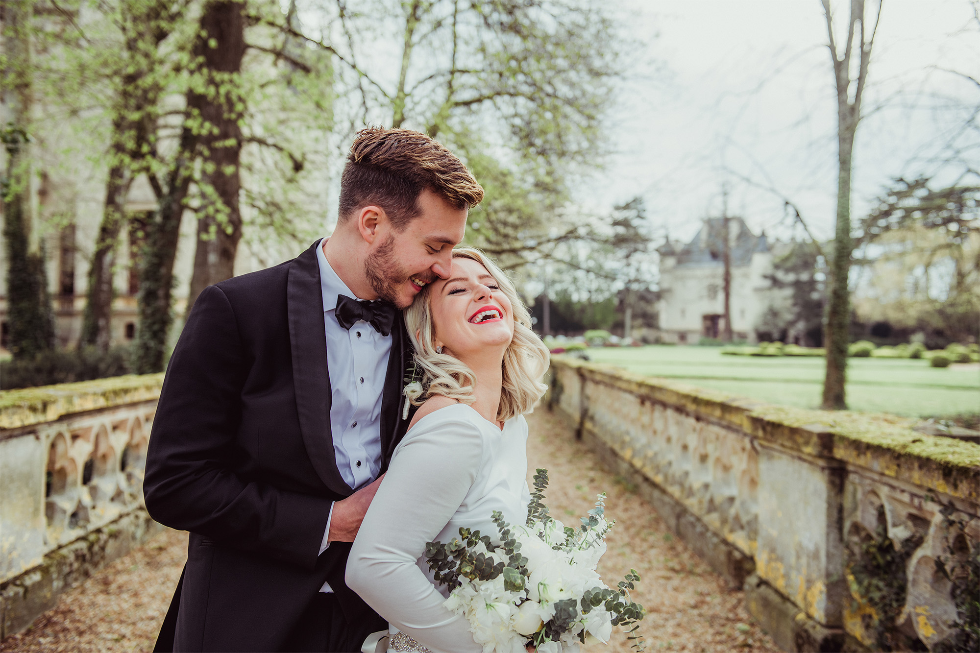 A couple's tender embrace against a breathtaking European backdrop, photographed by Janis Ratnieks, a renowned wedding photographer.