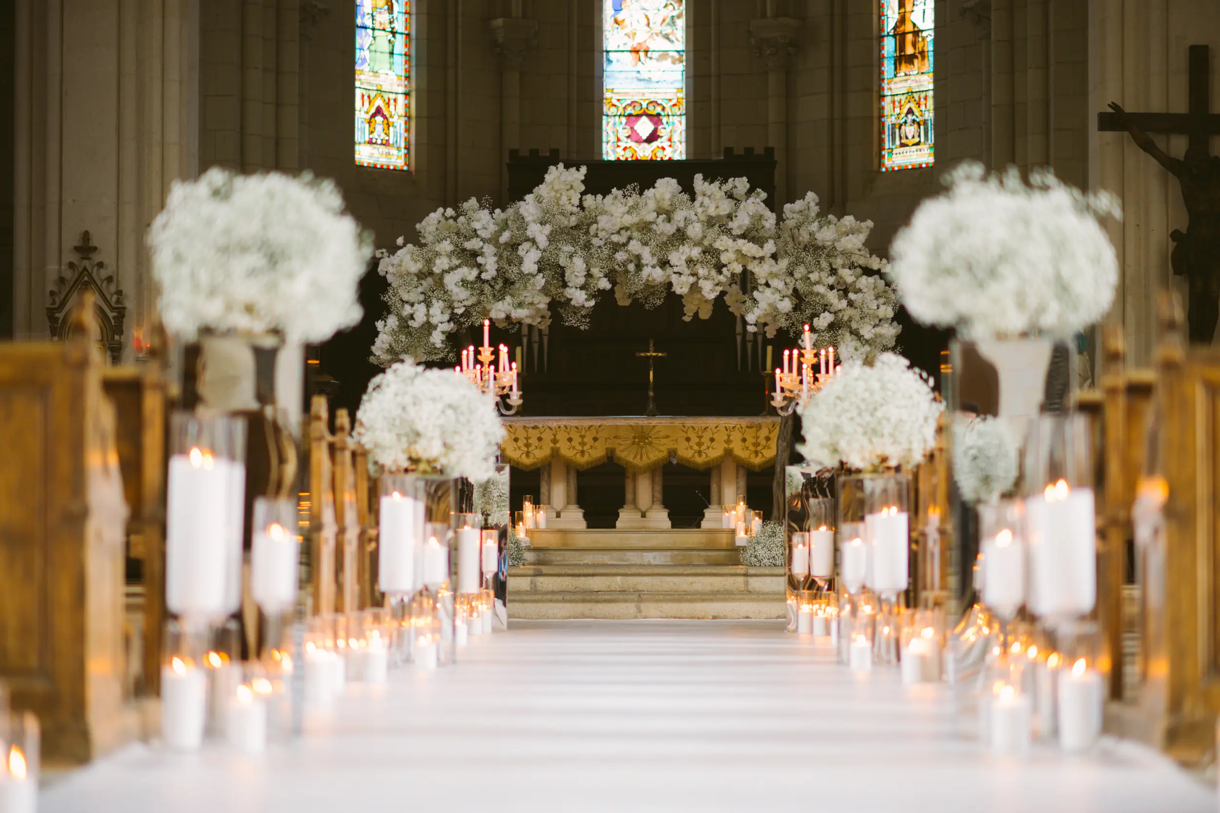 Chateau Challain wedding church ceremony with white candles and baby’s breath floral decorations