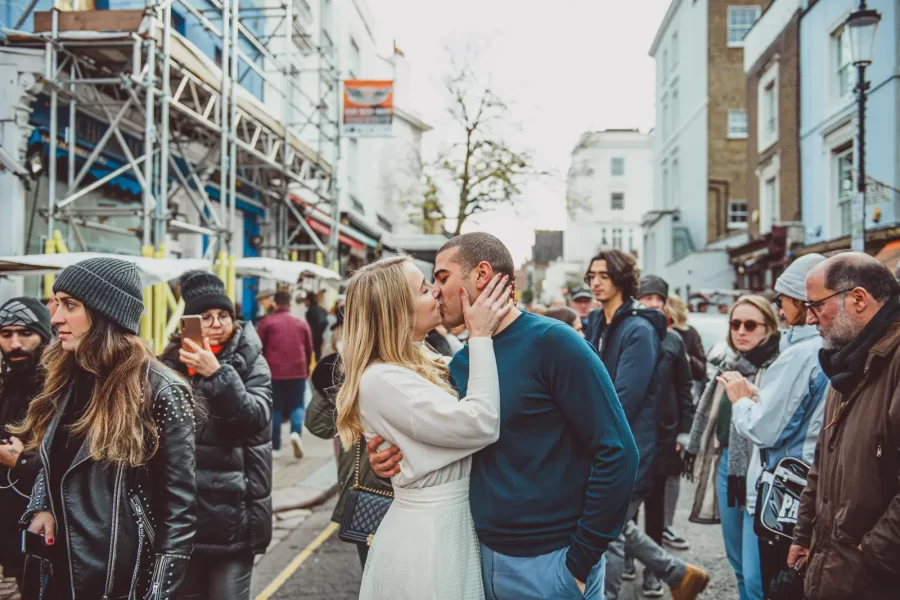 Erin and Khalid walking past colourful houses in Notting Hill during a London pre-wedding