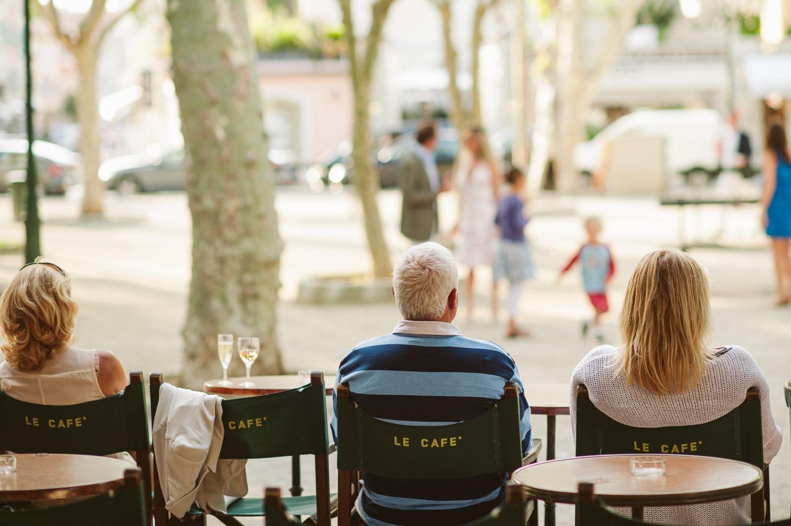 Guests laughing around tables at Saint-Tropez rehearsal dinner